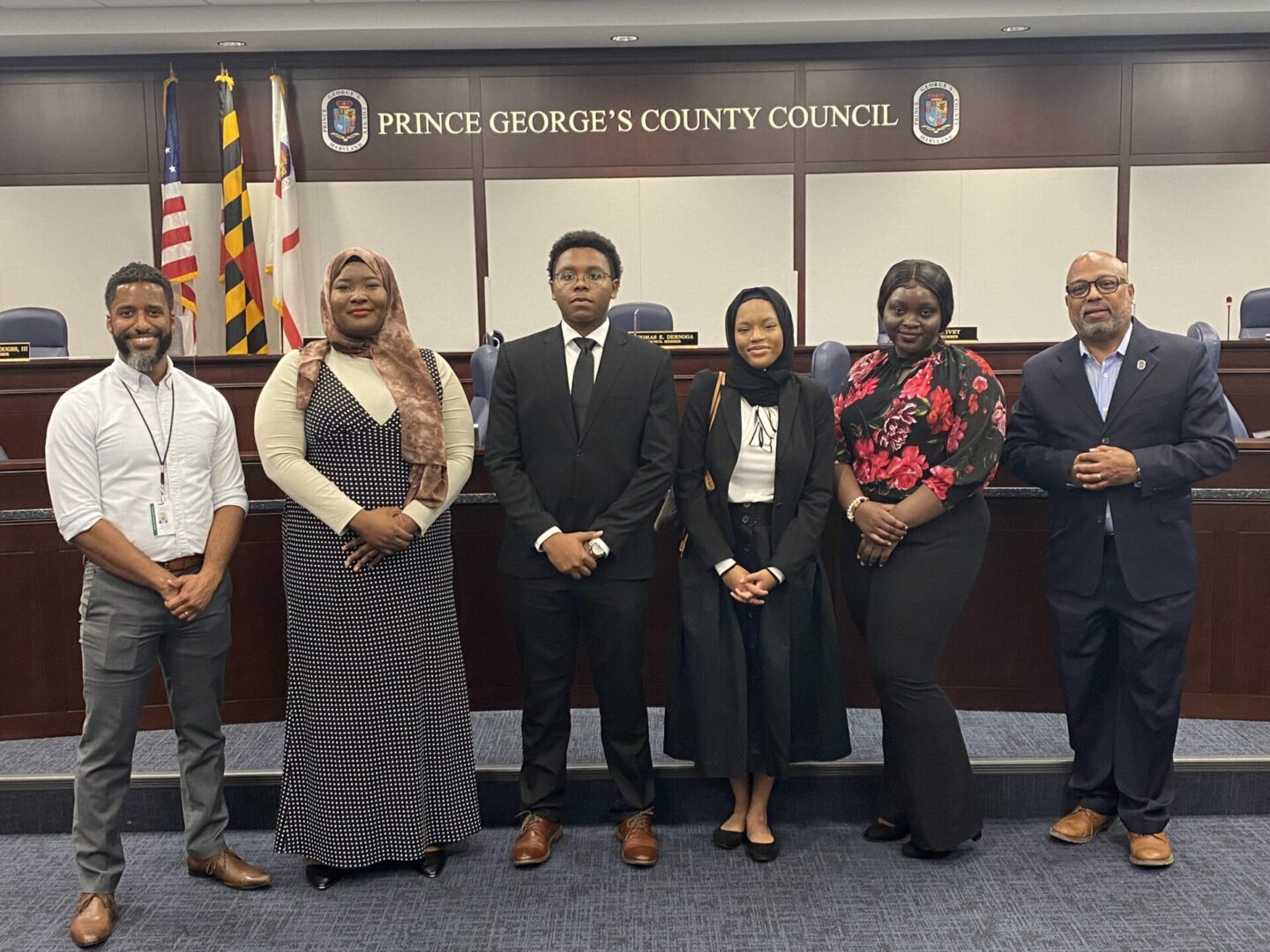 A group of people standing in front of a courtroom.