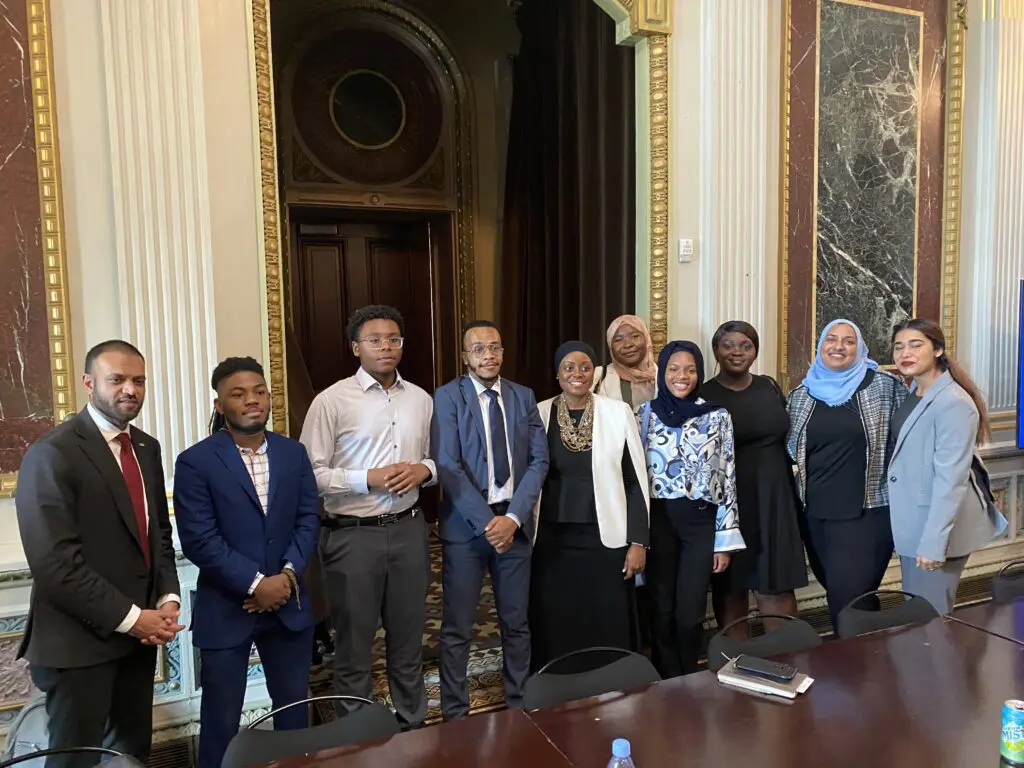 A group of people standing in front of a door.