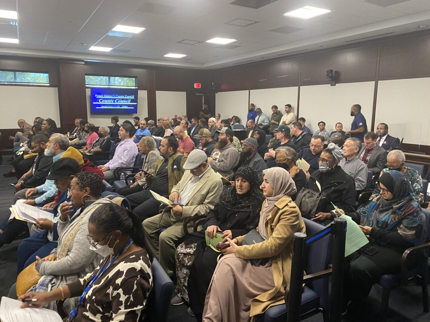 A large group of people sitting in a room.