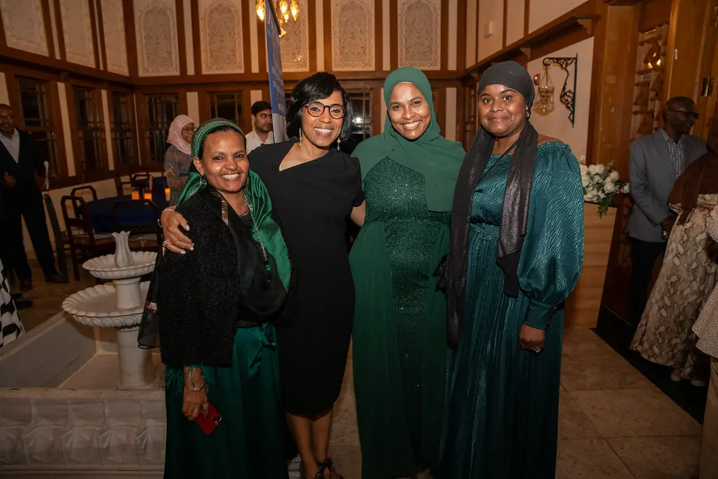 A group of women in green dresses posing for a photo.