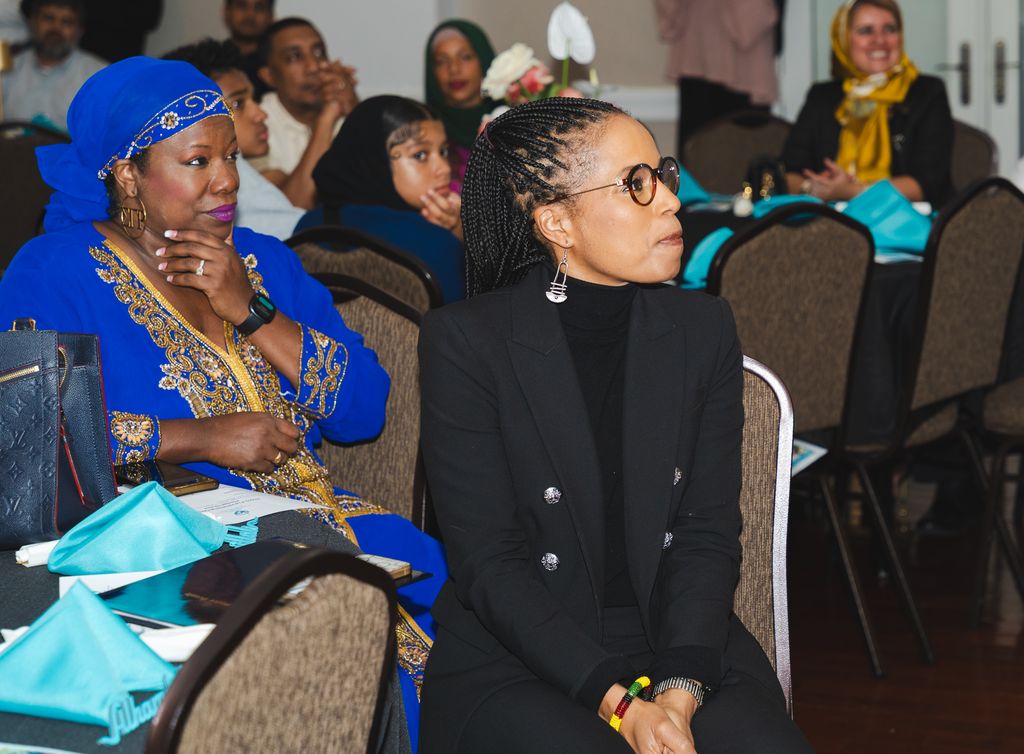 A group of people sitting in chairs.
